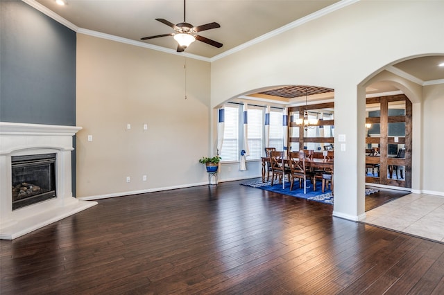 9848 Robinwoods Dr, Frisco, TX 75035 - unfurnished living room featuring a ceiling fan, hardwood / wood-style floors, ornamental molding, a glass covered fireplace, and baseboards
