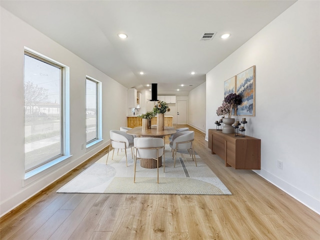 dining area featuring light wood-type flooring, visible vents, baseboards, and recessed lighting