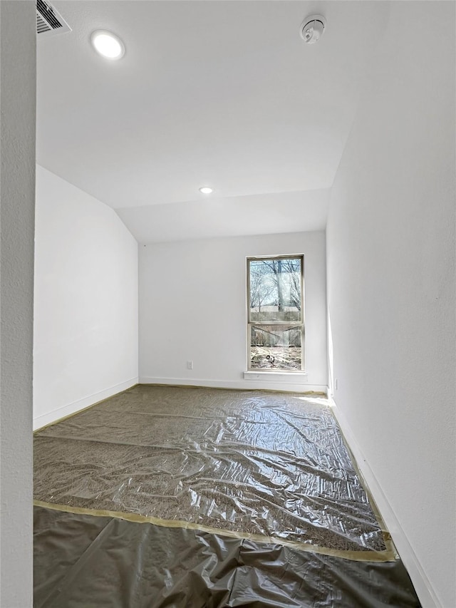 unfurnished room featuring lofted ceiling, recessed lighting, baseboards, and visible vents