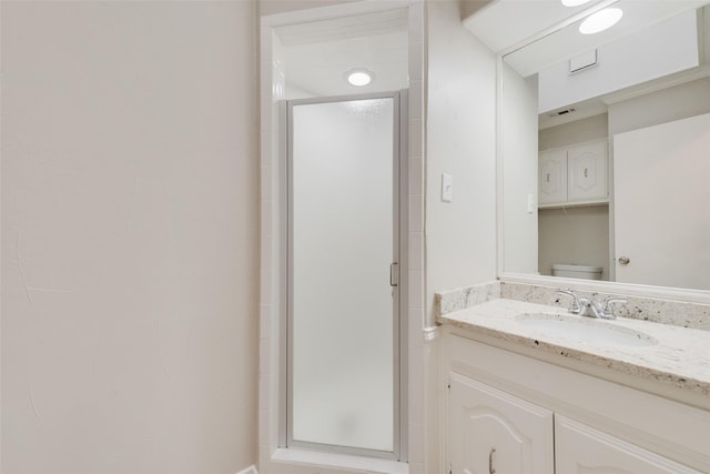 full bathroom with vanity, toilet, and a shower stall