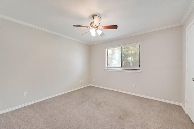 spare room with carpet flooring, ceiling fan, ornamental molding, and baseboards