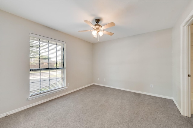 unfurnished room featuring ceiling fan, baseboards, and carpet