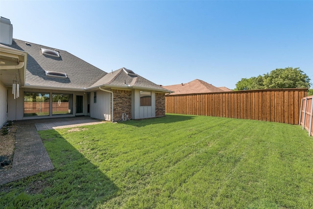 view of yard with a fenced backyard