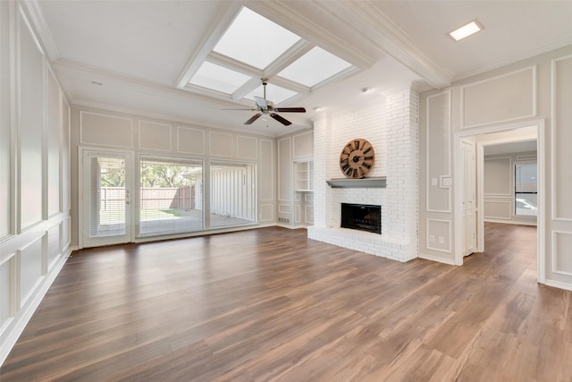 unfurnished living room with crown molding and a decorative wall
