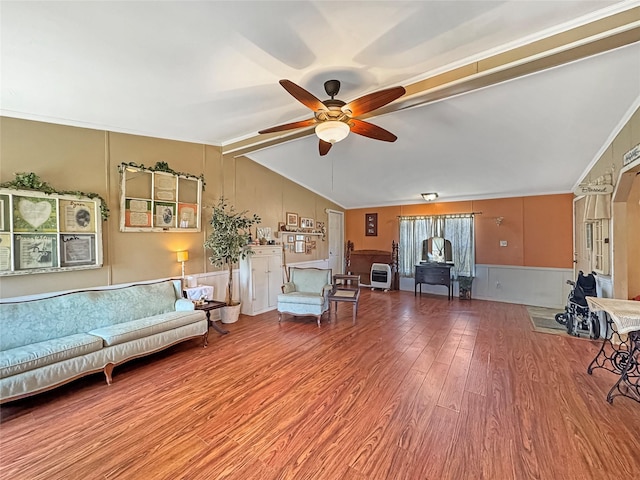 unfurnished living room with a ceiling fan, lofted ceiling with beams, and wood finished floors