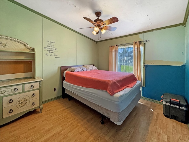 bedroom with light wood-style flooring, crown molding, vaulted ceiling, and ceiling fan