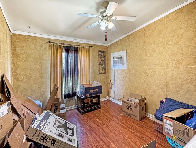 1791 County Road 3855, Poolville, TX 76487 - living area with crown molding, wood finished floors, ceiling fan, a wall mounted AC, and baseboards
