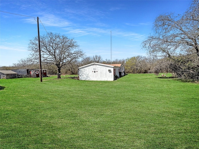 view of yard with an outbuilding and a storage shed