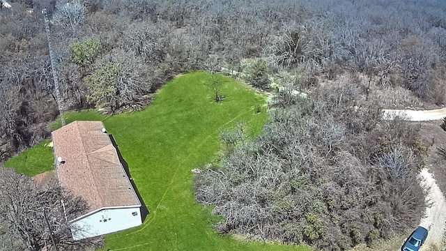 birds eye view of property featuring a view of trees