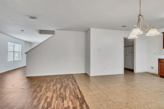 8529 Star Thistle Dr, Fort Worth, TX 76179 - unfurnished living room with light wood-style floors, visible vents, and baseboards