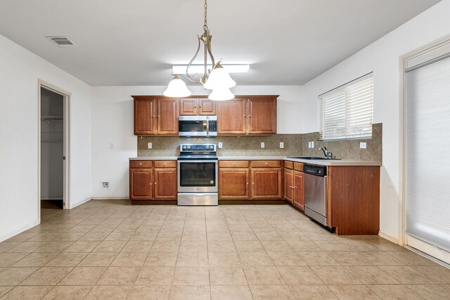 8529 Star Thistle Dr, Fort Worth, TX 76179 - kitchen with visible vents, light countertops, decorative backsplash, stainless steel appliances, and a sink