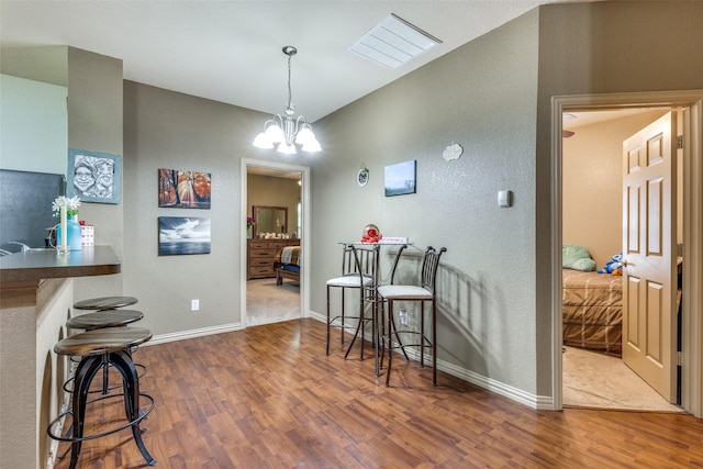 1017 Story Book Ln, Weatherford, TX 76086 - dining space with visible vents, a textured wall, baseboards, and wood finished floors
