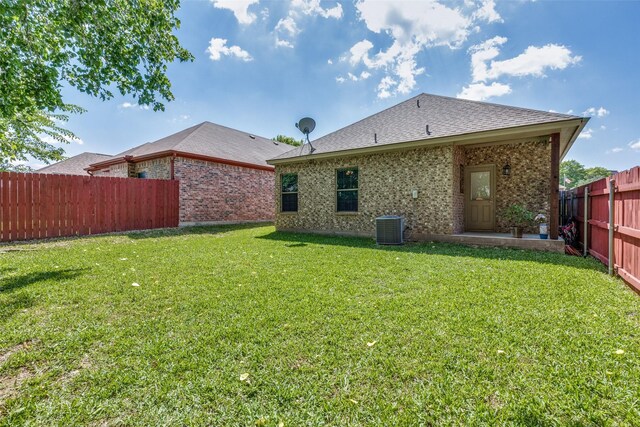 1017 Story Book Ln, Weatherford, TX 76086 - rear view of property featuring a fenced backyard, central AC unit, brick siding, a lawn, and a shingled roof