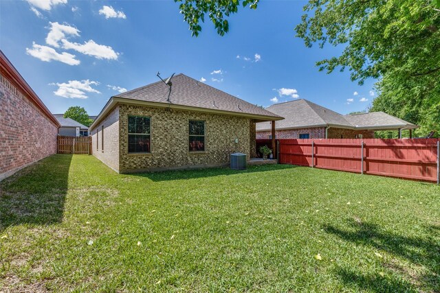1017 Story Book Ln, Weatherford, TX 76086 - rear view of property with central AC, a lawn, a shingled roof, a fenced backyard, and brick siding