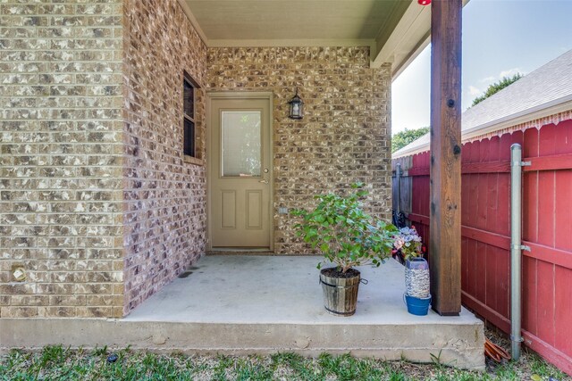 1017 Story Book Ln, Weatherford, TX 76086 - doorway to property with brick siding and fence