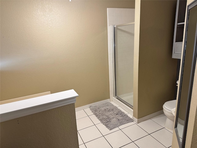 full bath with tile patterned floors, baseboards, toilet, and a shower stall