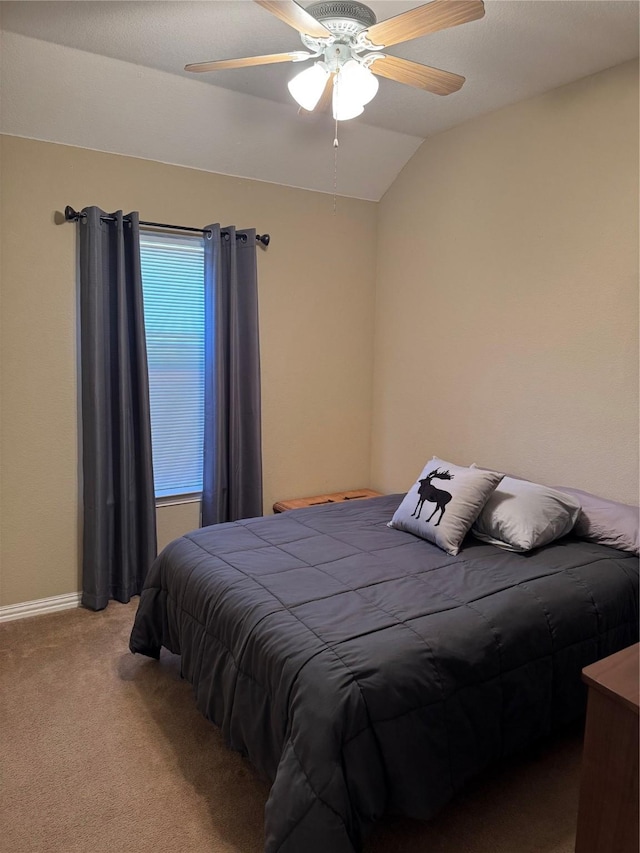 bedroom featuring baseboards, ceiling fan, carpet flooring, and vaulted ceiling