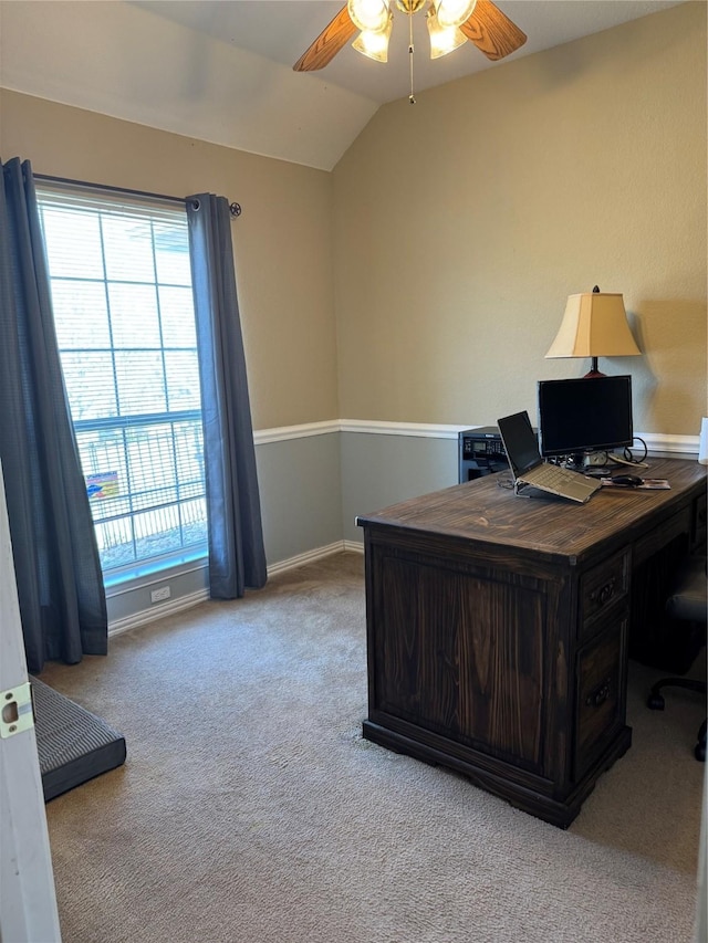 carpeted office featuring baseboards, ceiling fan, and vaulted ceiling