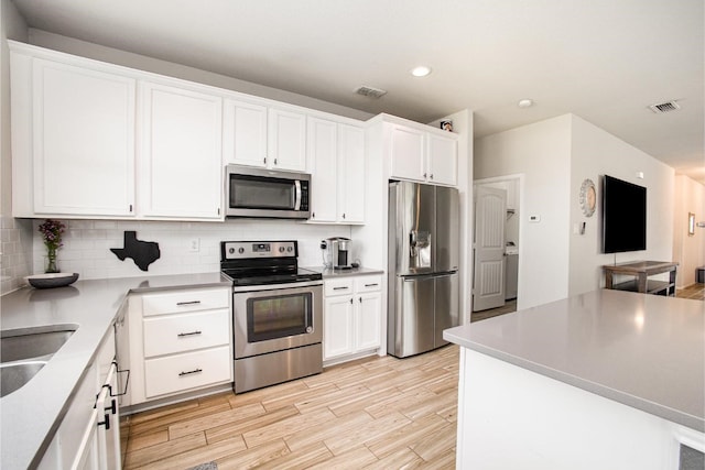 2015 Brenham Dr, Forney, TX 75126 - kitchen with stainless steel appliances, tasteful backsplash, white cabinetry, light wood-type flooring, and recessed lighting