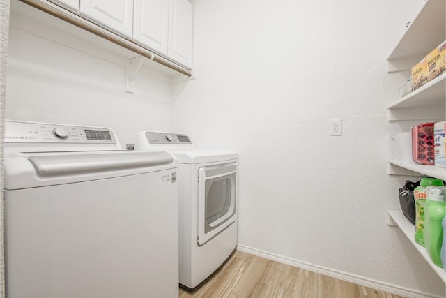 2015 Brenham Dr, Forney, TX 75126 - washroom with washer and clothes dryer, cabinet space, light wood-type flooring, and baseboards
