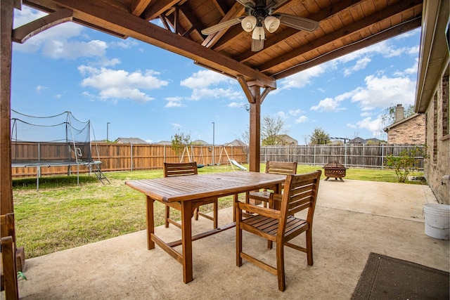 2015 Brenham Dr, Forney, TX 75126 - view of patio with a trampoline, a ceiling fan, an outdoor fire pit, and outdoor dining area