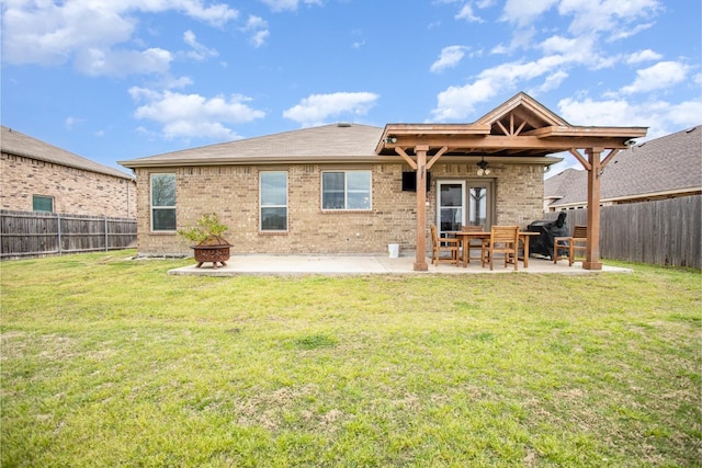 2015 Brenham Dr, Forney, TX 75126 - rear view of property featuring a ceiling fan, an outdoor fire pit, a patio, and brick siding