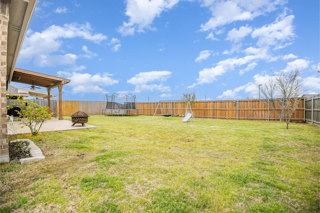2015 Brenham Dr, Forney, TX 75126 - view of yard featuring a trampoline, a fire pit, ceiling fan, and a patio area