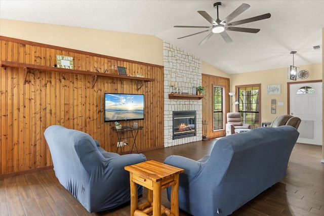 251 Dunn Dr, Palo Pinto, TX 76484 - living area with ceiling fan, a fireplace, wood finished floors, vaulted ceiling, and wood walls