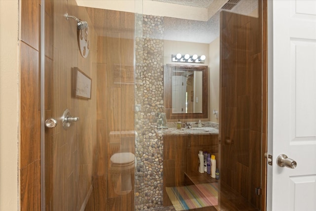 251 Dunn Dr, Palo Pinto, TX 76484 - full bathroom with a tile shower, a textured ceiling, and vanity