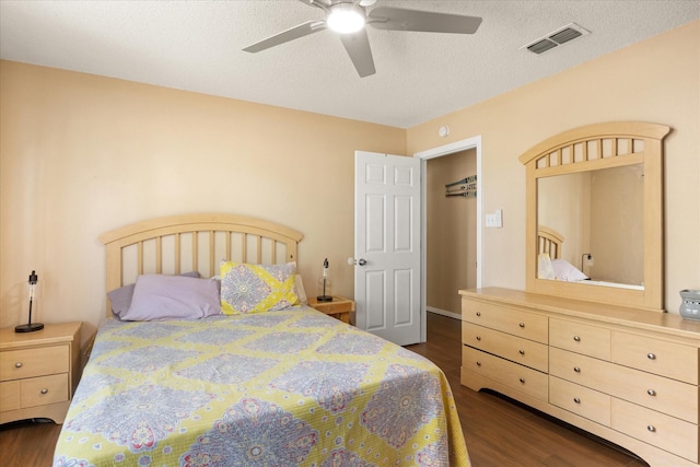 251 Dunn Dr, Palo Pinto, TX 76484 - bedroom with dark wood-type flooring, a ceiling fan, and a textured ceiling