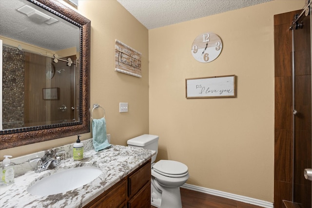 251 Dunn Dr, Palo Pinto, TX 76484 - bathroom featuring a textured ceiling, vanity, toilet, a shower with curtain, and wood finished floors