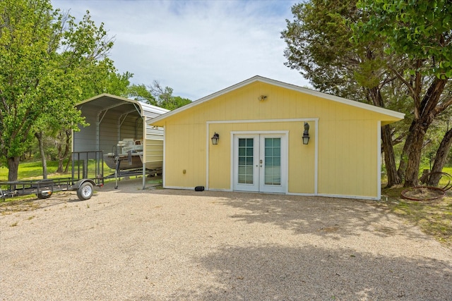 251 Dunn Dr, Palo Pinto, TX 76484 - rear view of property with french doors and a detached carport