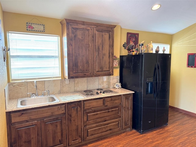 251 Dunn Dr, Palo Pinto, TX 76484 - kitchen featuring black fridge with ice dispenser, a sink, stainless steel electric cooktop, tasteful backsplash, and recessed lighting