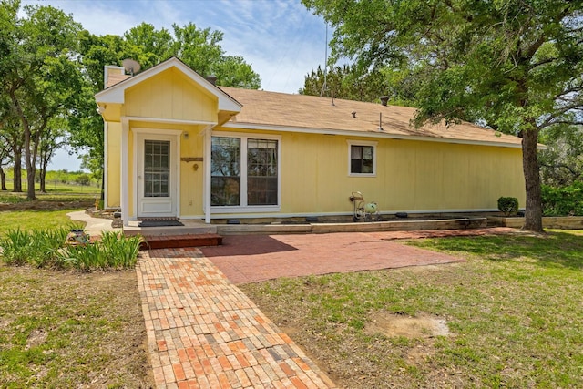 251 Dunn Dr, Palo Pinto, TX 76484 - view of front of house featuring a chimney and a front lawn