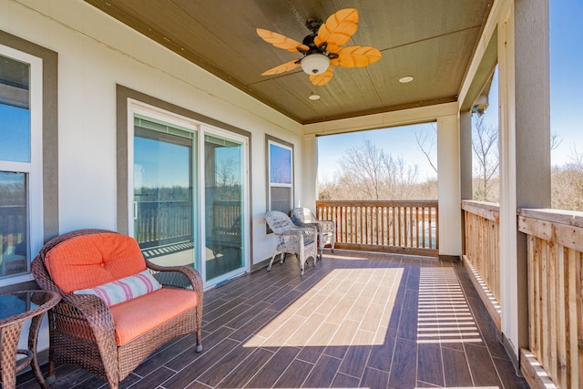 wooden terrace with a ceiling fan