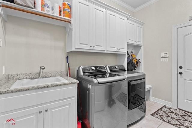 3032 Sagefield Ln, Haughton, LA 71037 - laundry area featuring ornamental molding, cabinet space, washing machine and dryer, light tile patterned floors, and baseboards