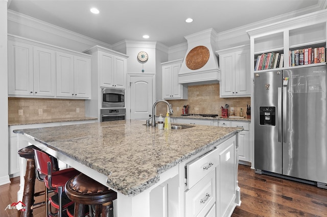 3032 Sagefield Ln, Haughton, LA 71037 - kitchen with appliances with stainless steel finishes, a sink, white cabinetry, an island with sink, and recessed lighting