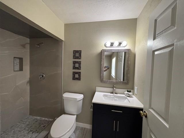 128 W Way Dr, Allen, TX 75002 - full bath featuring baseboards, toilet, walk in shower, and vanity