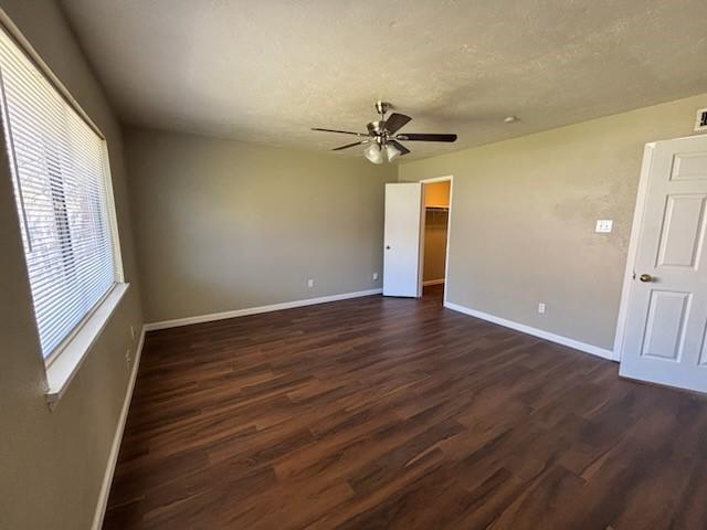 128 W Way Dr, Allen, TX 75002 - empty room featuring dark wood-style floors, a textured ceiling, baseboards, and ceiling fan