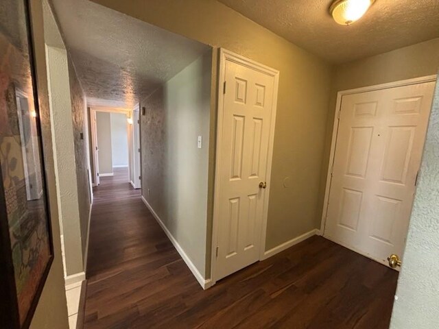 128 W Way Dr, Allen, TX 75002 - hallway with a textured ceiling, baseboards, and dark wood-style flooring