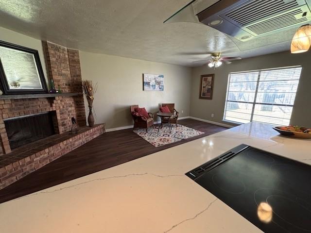 128 W Way Dr, Allen, TX 75002 - living area featuring baseboards, a textured ceiling, ceiling fan, and a fireplace