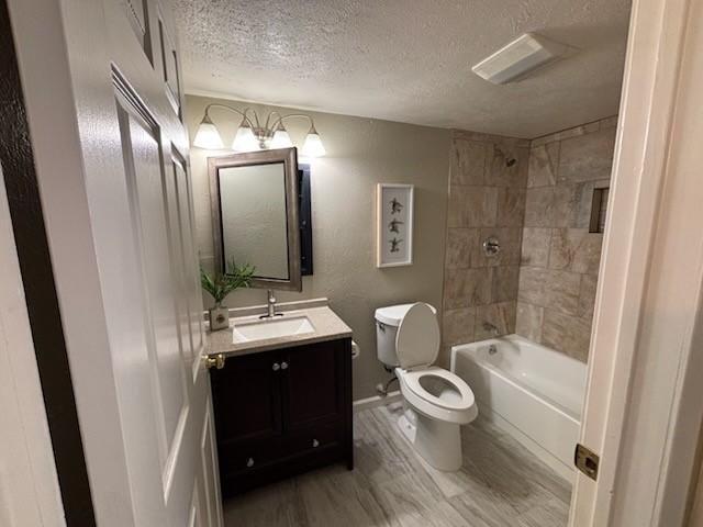 128 W Way Dr, Allen, TX 75002 - bathroom with toilet, shower / bath combination, vanity, wood finished floors, and a textured ceiling