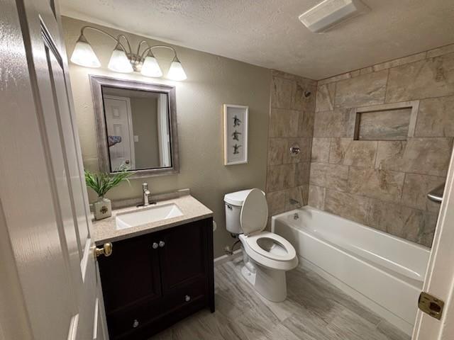 128 W Way Dr, Allen, TX 75002 - full bath with toilet, shower / tub combination, a textured ceiling, wood finished floors, and vanity