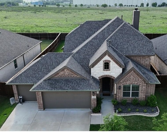 view of front of property with brick siding and roof with shingles
