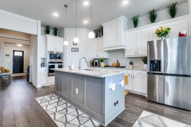 kitchen featuring a sink, white cabinets, stainless steel appliances, and dark wood-type flooring