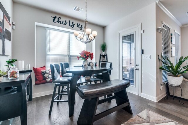 dining space with visible vents, ornamental molding, a chandelier, and a healthy amount of sunlight