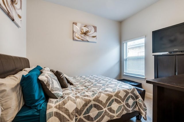 bedroom with carpet floors and baseboards
