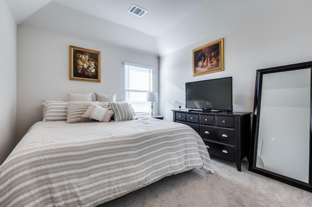 carpeted bedroom with vaulted ceiling and visible vents