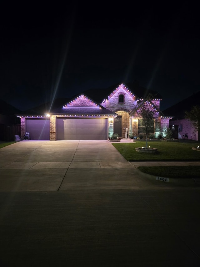 mediterranean / spanish-style house with an attached garage, a lawn, driveway, and a tiled roof