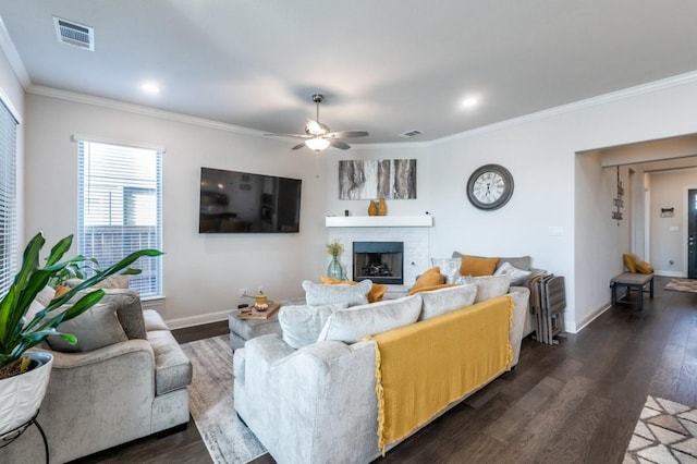 living room with crown molding, ceiling fan, dark wood-style floors, and visible vents